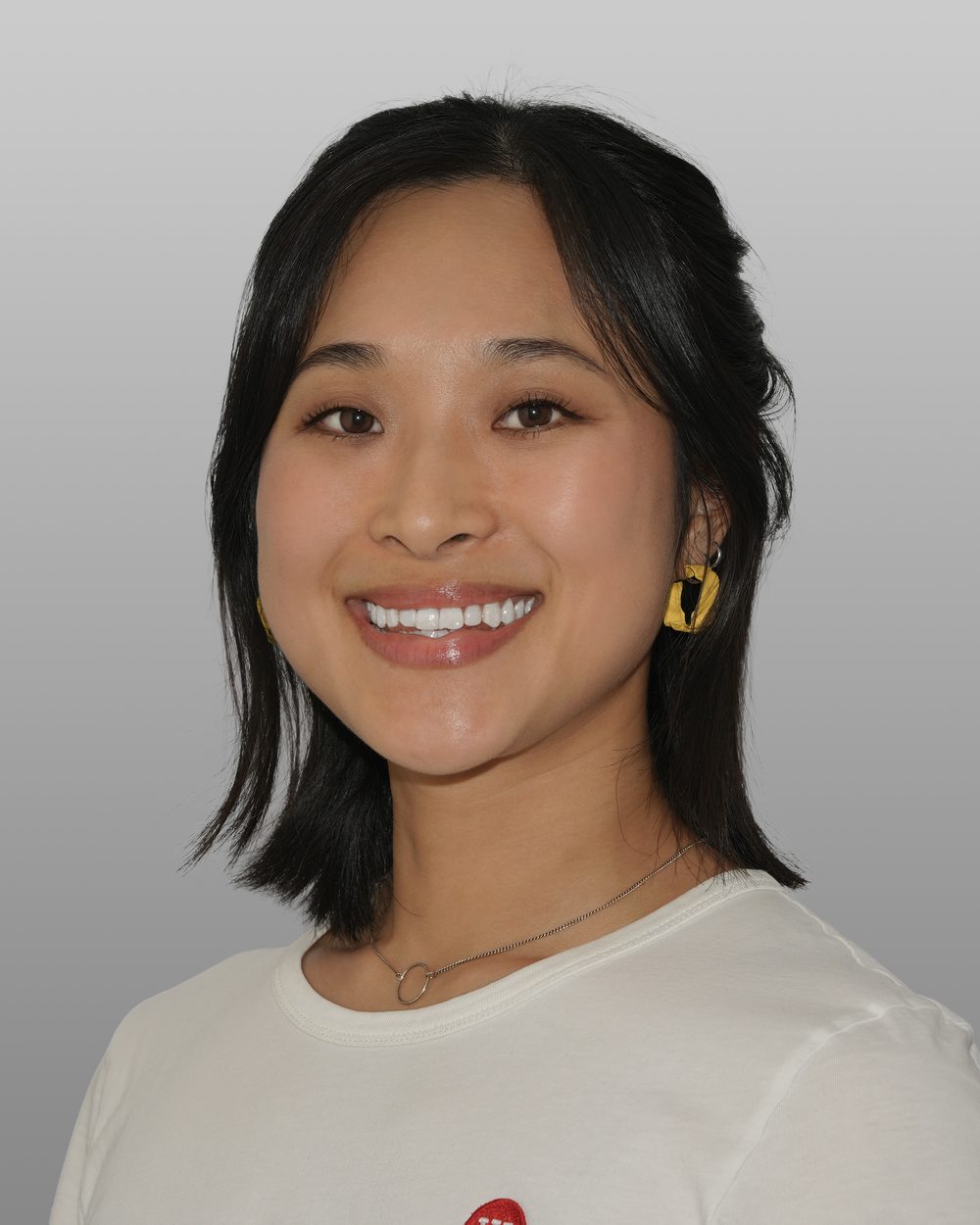 Corporate headshot of a Xero team member on a grey studio background