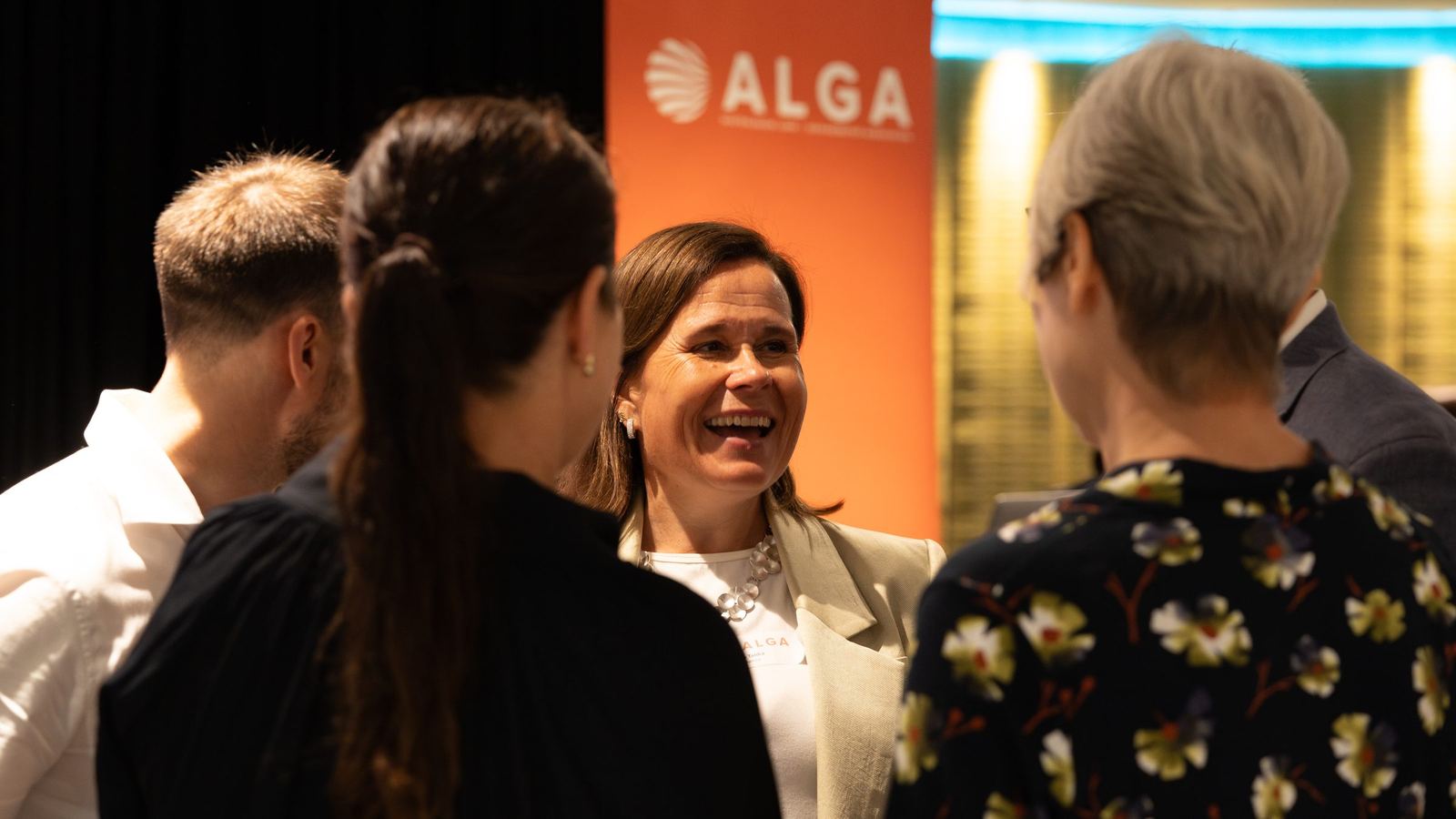 Guest laughing with colleagues