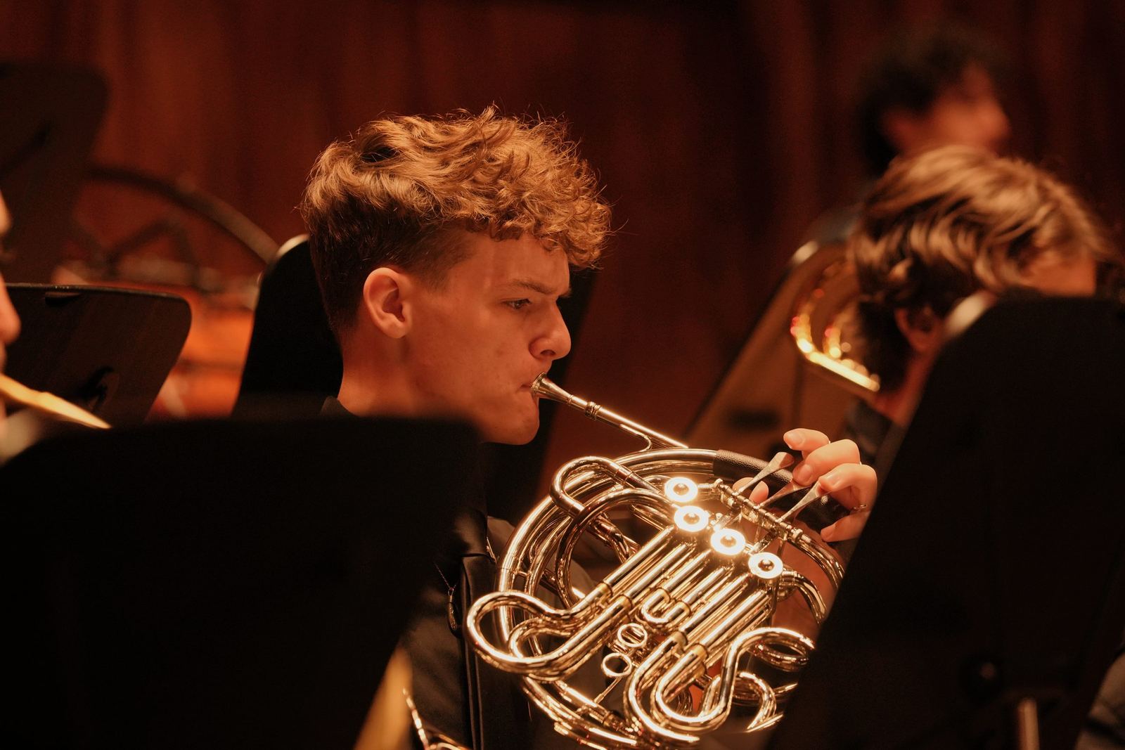 French horn player on stage