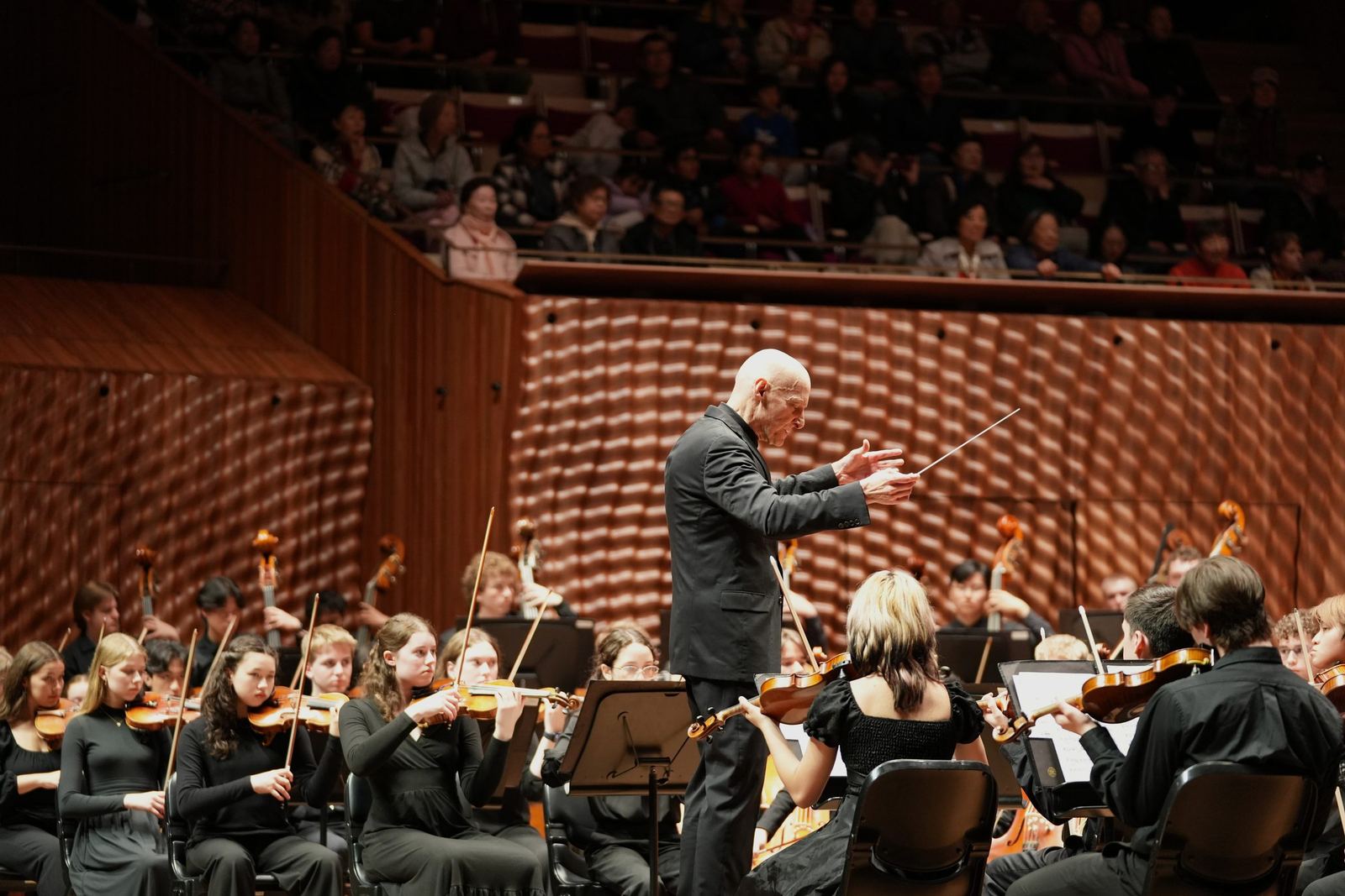 Conductor leading the violins in the Concert Hall